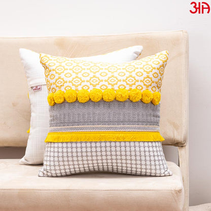 yellow pompom cushion